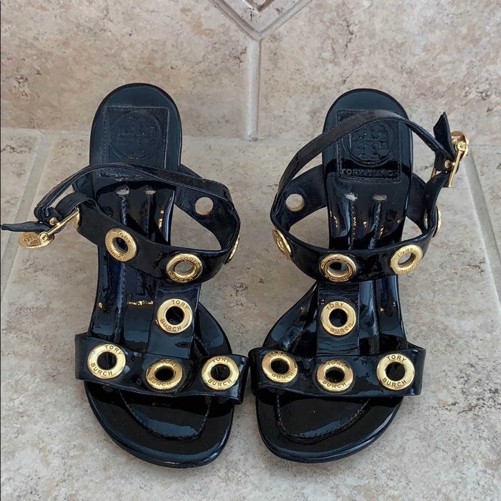 Tory Burch patent leather wedges with gold detail.